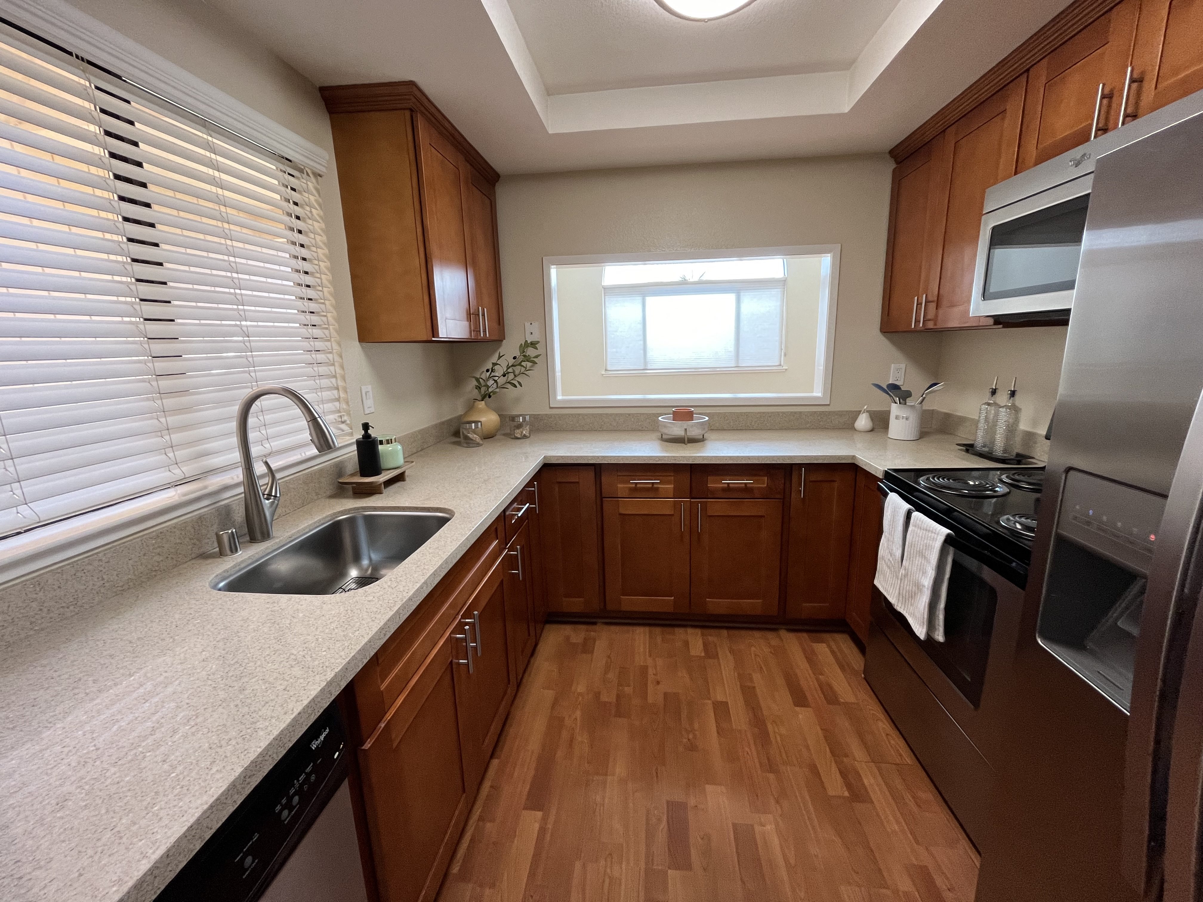 A kitchen with wooden cabinets and a white countertop.